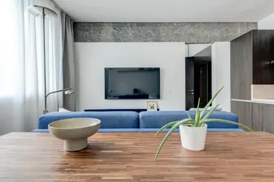 a living room with a blue couch and a table at Splendid 1BDMApartment Near Shopping Mall & Metro in Sofia