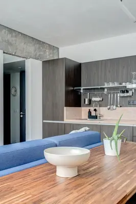 a living room with a blue couch and a table at Splendid 1BDMApartment Near Shopping Mall & Metro in Sofia
