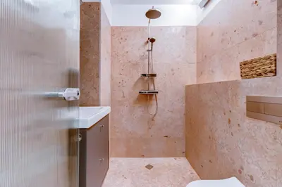 a bathroom with a shower with a toilet and a sink at Splendid 1BDMApartment Near Shopping Mall & Metro in Sofia
