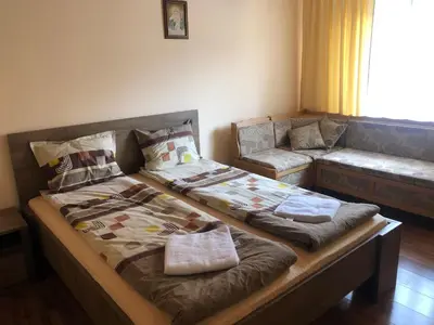 a bedroom with two beds and a couch at Guest House Robin Hud in Cherni Osŭm