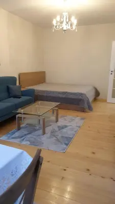 a living room with a couch and a coffee table at Sunny and Charming Domain for Your Stay in Sofia in Sofia
