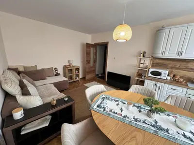 a living room with a table and a couch at Lovely cozy vintage apartment in Kyustendil