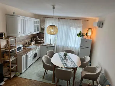 a kitchen with a table and a table and chairs at Lovely cozy vintage apartment in Kyustendil