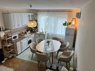a kitchen with a table and chairs in a room at Lovely cozy vintage apartment in Kyustendil
