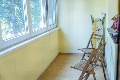 a wooden chair in a room with a window at The Lindens 1 Bedroom Cozy Apartment plus Free Parking!!! in Sofia