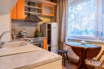 a kitchen with orange cabinets and a sink and a window at The Lindens 1 Bedroom Cozy Apartment plus Free Parking!!! in Sofia