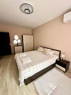 a bedroom with a large bed and a ceiling at TVS Apartment-City centre in Plovdiv