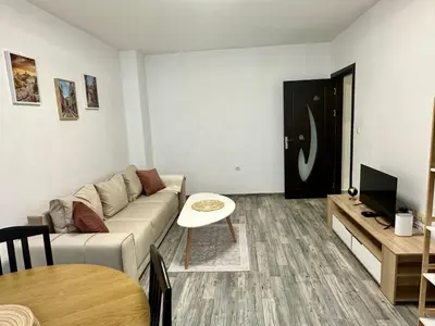 a living room with a couch and a table at TVS Apartment-City centre in Plovdiv