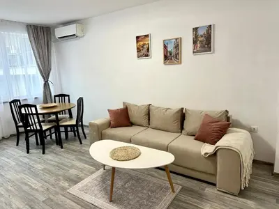 a living room with a couch and a table at TVS Apartment-City centre in Plovdiv