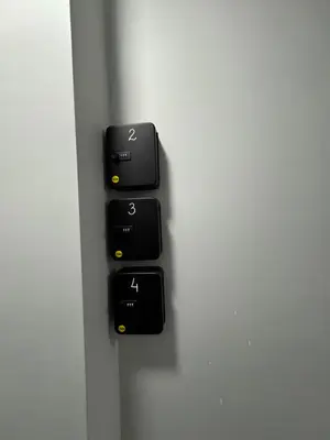 a bunch of black electrical switches on a wall at Dream Home A3 in Sofia