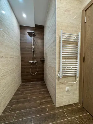 a bathroom with a shower and a tile wall at Dream Home A3 in Sofia