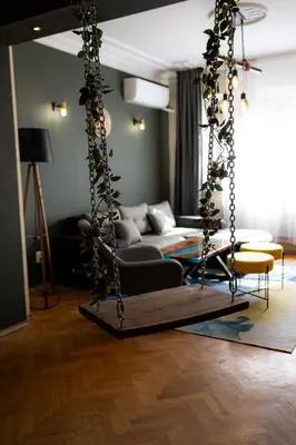 a swing in a living room with a couch at 1 Minute Walk to Main Street Vitoshka, NDK, Free Parking, 2 BDR in Sofia