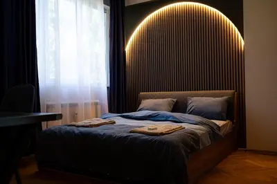 a bedroom with a bed with two towels on it at 1 Minute Walk to Main Street Vitoshka, NDK, Free Parking, 2 BDR in Sofia