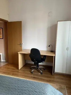 a desk with a chair and a mirror in a room at Spacious artsy apartment in Sofia