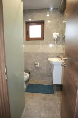 a bathroom with a toilet and a sink at Nara in Pchelin