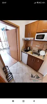 a small kitchen with a sink and a microwave at Comfy Studio in Bansko