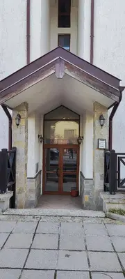 a entrance to a building with a brown door at Comfy Studio in Bansko