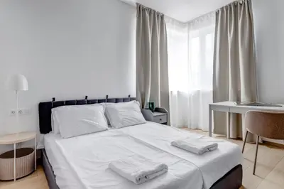 a bedroom with a white bed with two towels on it at Modern 1BDMApartment Near Shopping Mall & Metro in Sofia