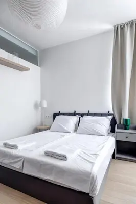 a bedroom with a large bed with white sheets at Modern 1BDMApartment Near Shopping Mall & Metro in Sofia