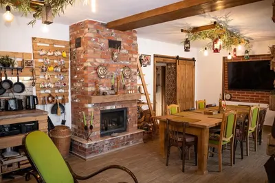 a dining room with a table and a fireplace at Yaninata Art House in Teteven in Teteven