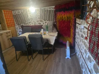 a small room with a table and chairs in a room with a room at Mountain Whisper Guesthouse in Smolyan