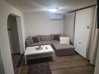 a living room with a couch and a table at Mountain Whisper Guesthouse in Smolyan