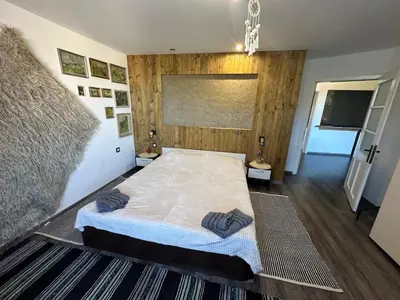 a bedroom with a bed with two pillows on it at Mountain Whisper Guesthouse in Smolyan