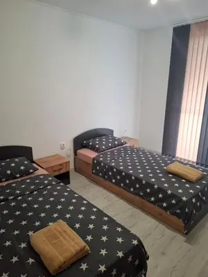 two beds in a room with an american flag pattern at Апартамент Актив Спорт Гранд in Pazardzhik
