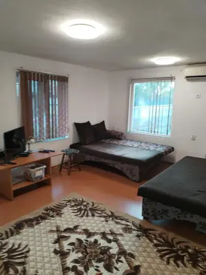 a living room with a couch and a table at Вила 