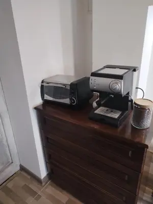 a microwave and toaster oven sitting on a dresser at Вила 
