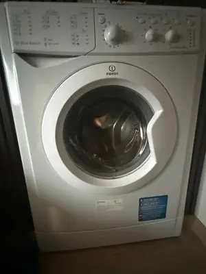 a white washing machine is in a room at Rose studio - Bulgaria mall, Brand New, Ground floor, Family-friendly, Baby cot&chair, Mountain view, Self check-in, Free Public parking and Paid underground in the mall in Sofia