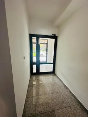 an empty room with a door and a hallway at Rose studio - Bulgaria mall, Brand New, Ground floor, Family-friendly, Baby cot&chair, Mountain view, Self check-in, Free Public parking and Paid underground in the mall in Sofia