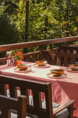 a table with bowls and plates of food on a balcony at Хижа Кукер - Арт Хижа за Вдъхновение и Отдих in Sofia