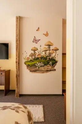 a wall mural of mushrooms and butterflies at Хижа Кукер - Арт Хижа за Вдъхновение и Отдих in Sofia