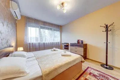 a bedroom with a large bed and a window at Bright retreat with Balcony & Mountain Views by Flat Manаger in Smolyan