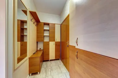 a room with wooden cabinets and a hallway at Bright retreat with Balcony & Mountain Views by Flat Manаger in Smolyan