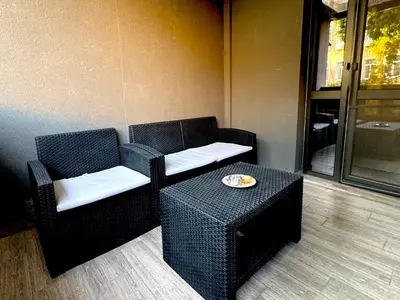 two chairs and a table with a plate of food at Studio Sredec 77 in Plovdiv