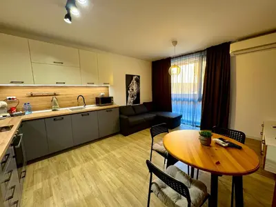 a kitchen and living room with a table and a kitchen and a dining room at Studio Sredec 77 in Plovdiv