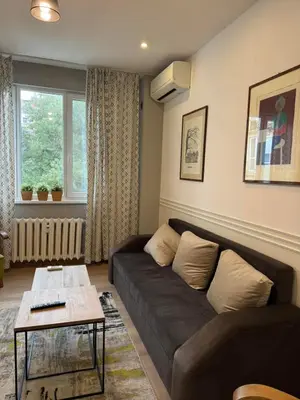 a living room with a couch and a table at Happy Day in Sofia