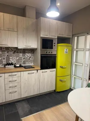 a kitchen with a yellow refrigerator and a table at Happy Day in Sofia