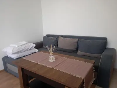 a living room with a couch and a table at Apartment B35, complex Sokolitsite in Pamporovo