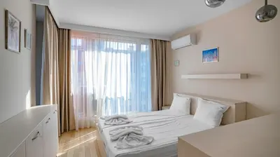 a small bedroom with a bed and a window at Modern & Spacious Stay by Flat Mаnager in Sofia