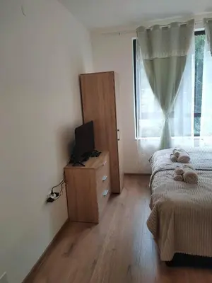 a bedroom with a bed and a television on a dresser at Apartment B34, complex Sokolitsite in Smolyan