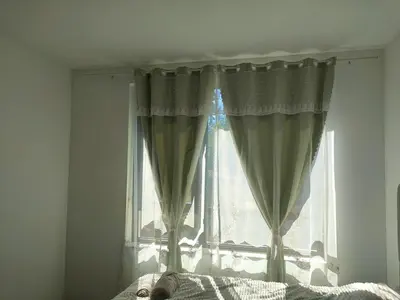 a bedroom window with curtains on a bed at Apartment B34, complex Sokolitsite in Smolyan