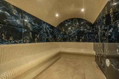 a bathroom with a walk in shower and a shower at East Plaza Hotel in Sofia