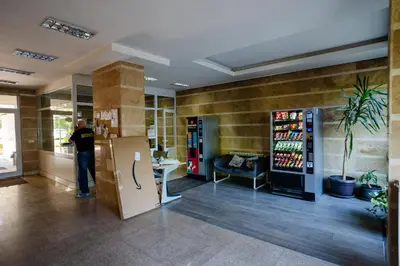 a man standing in a room with a refrigerator at Mountain View Sky Apartment Ori 4 in Sofia