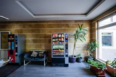 a room with a soda vending machine and a chair at Mountain View Sky Apartment Ori 4 in Sofia