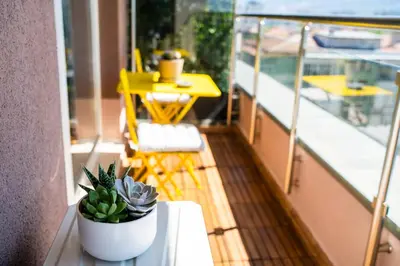 a balcony with a table and potted plants on it at Mountain View Sky Apartment Ori 4 in Sofia