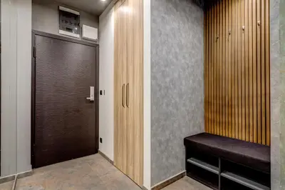 a walk in closet with a wooden door and a bench at Sophisticated 2BDRM 2BATH and Billiard in Sofia