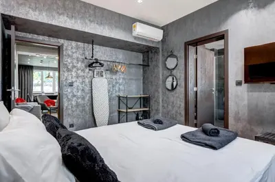 a bedroom with a large bed with towels on it at Sophisticated 2BDRM 2BATH and Billiard in Sofia